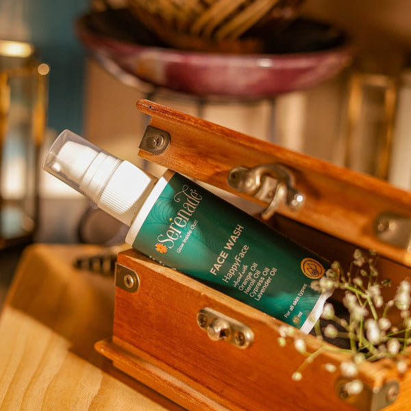 Serenade HappyFace Face Wash with Orange, Neroli, Cypress and Lavender essential oils placed in a wooden box for aromatherapy skincare and glowing skin routine