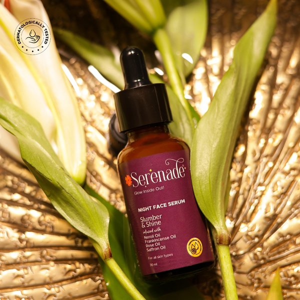 Serenade Slumber & Shine Night Face Serum with Neroli, Rose, Frankincense and Saffron essential oils placed in a warm natural setting for overnight aromatherapy skincare